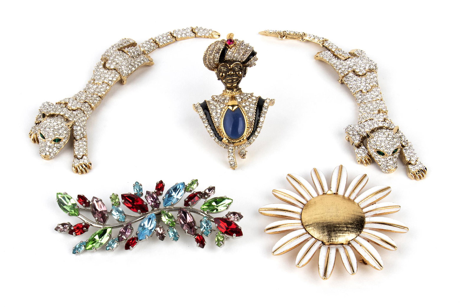 LOT OF FIVE BROOCHES 70s/80s: LOT OF FIVE BROOCHES 70s/80s A lot of five brooches: 1) Two gilded metal rhinestones panther shape brooches, no marks 2) A gilded metal rhinestones blue glass paste enamel blacamoor brooch, no mark 3)