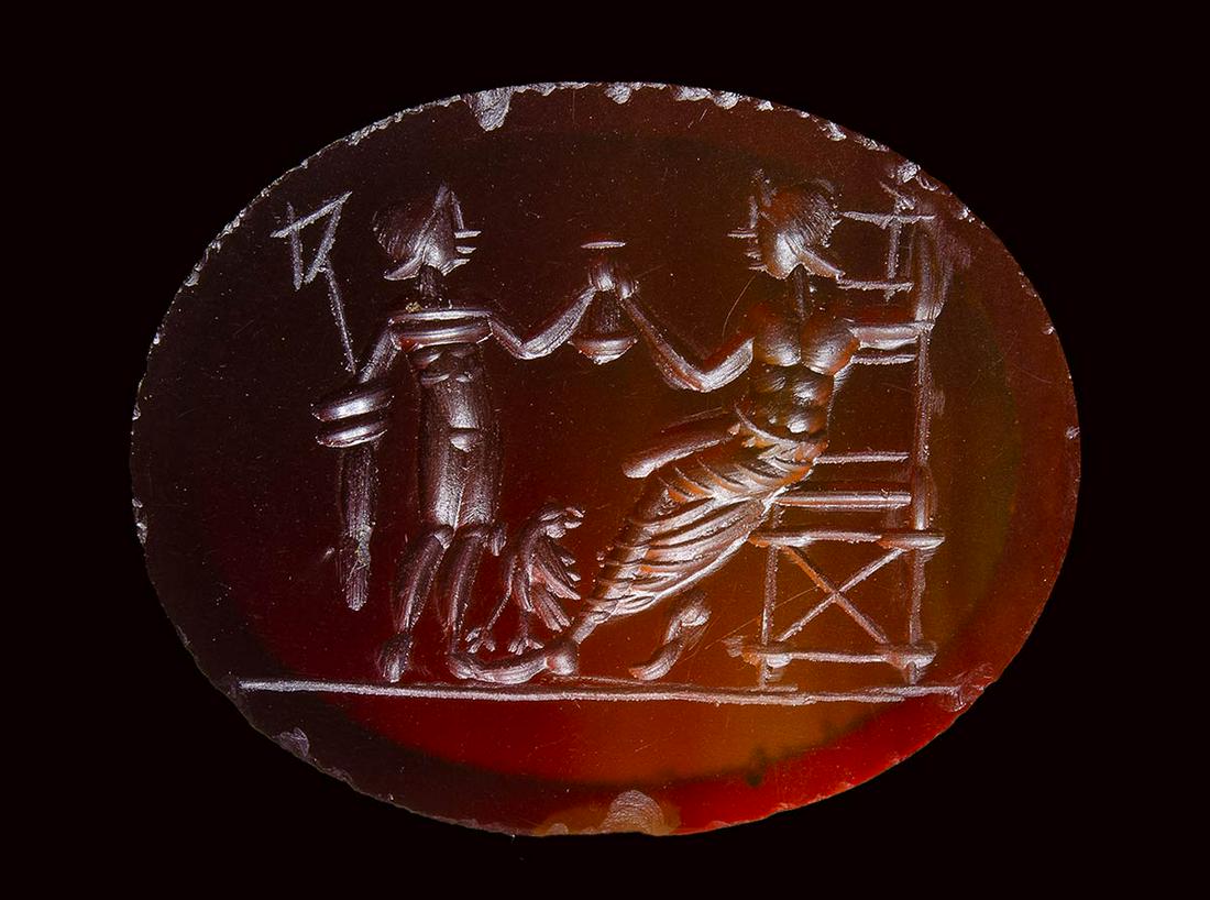 A large roman carnelian intaglio. Mythological scene.: A large roman carnelian intaglio. Mythological scene. 2nd - 3rd century A.D. 21,5 x 27 x 3 mm On the left side, the standing figure of Hermes is holding the caduceus and facing Zeus seated on his thro