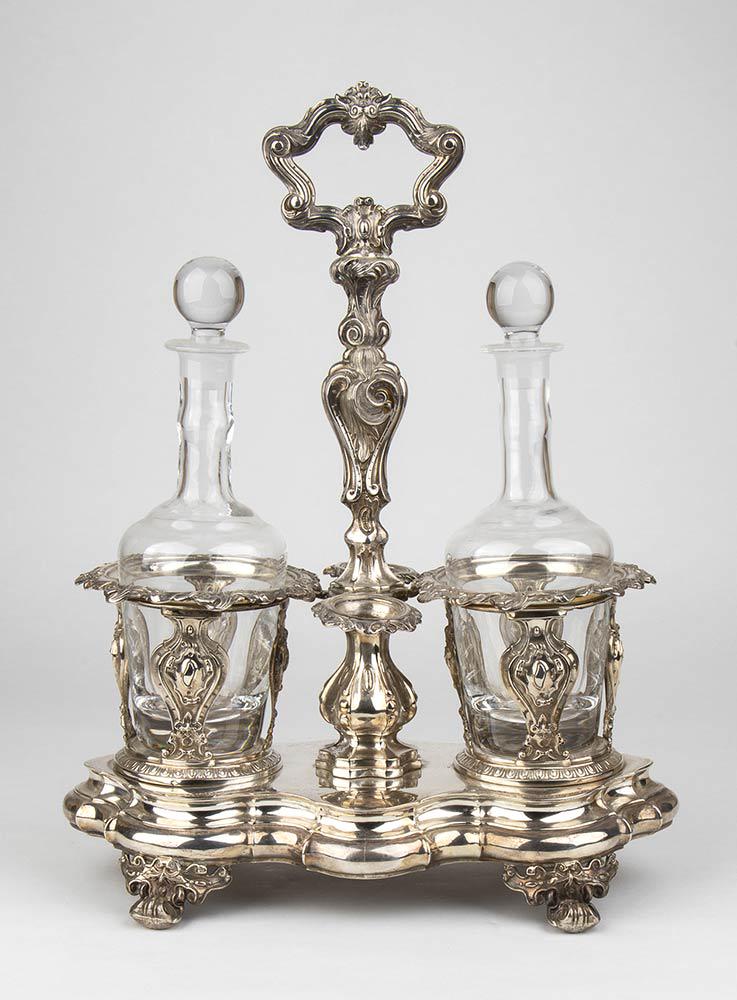 French 950/1000 silver oil and vinegar set - Paris: cartouche shaped, fused, chased and embossed silver resting on four foliate foot. Fully hallmarked with French marks after 1838 used in Paris for 950/1000 silver, silversmith Alphonse Debain. Height 3