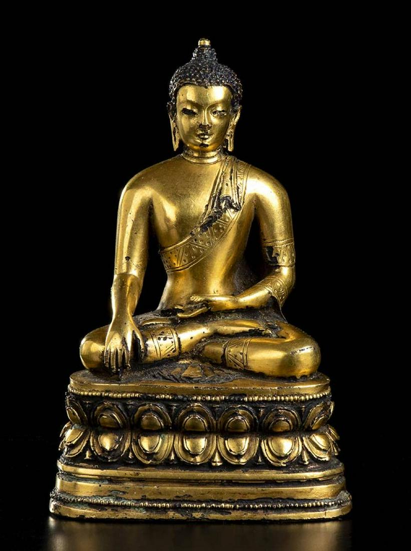 A GILT BRONZE BUDDHA Mongolia, Zanabazar School style: A GILT BRONZE BUDDHA Mongolia, Zanabazar School style Sitting on a double lotus flower base, the legs crossed in dhyanasana position, left hand on lap and right hand placed on the right knee. 17 cm hi