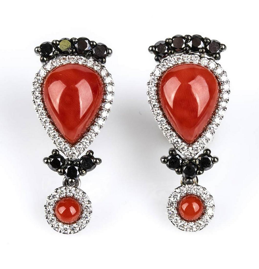Gold, Mediterranean coral and black and white diamonds: Gold, Mediterranean coral and black and white diamonds earrings 18k white gold, each with cabochon cut Mediterranean coral (corallium rubrum) surrounded by white brilliant cut diamonds ca. 0.85 ct tot