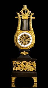 French Lyre mantle clock: Height x width x depth: 39 x 13 x 7.5 cm.?burnished bronze structure, circular dial with white enamel bezel and openwork gilt bronze centre, framed by a gilt bronze lyre, movement with wire suspension