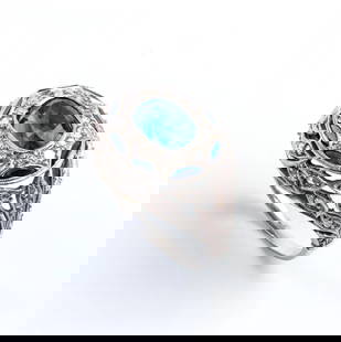 Sapphire diamond platinum ring: openwork floral motifs band set with huit-huit and rose-cut diamonds, centered by an oval sapphire surrounded by other sapphires in the shape of a crescent moon.N. 01 blue sapphire, oval shape, compos