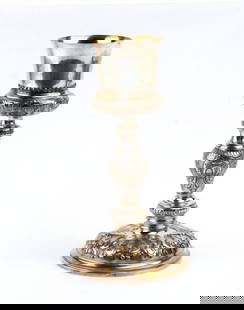 Italian silver calix: in silver made by embossing and chiselling, with a circular base, baluster stem and central knot, the bowl gilded on the inside. The whole surface is richly decorated with foliate and floral motifs an