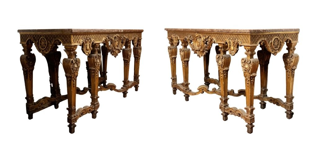 A pair of large carved and gilded wooden consoles with Louis XVI-style marble tops - 19th century: A pair of large carved and gilded wooden consoles with Louis XVI-style marble tops - 19th centuryan important pair of wall-mounted consoles, characterized by an architectural structure with six front