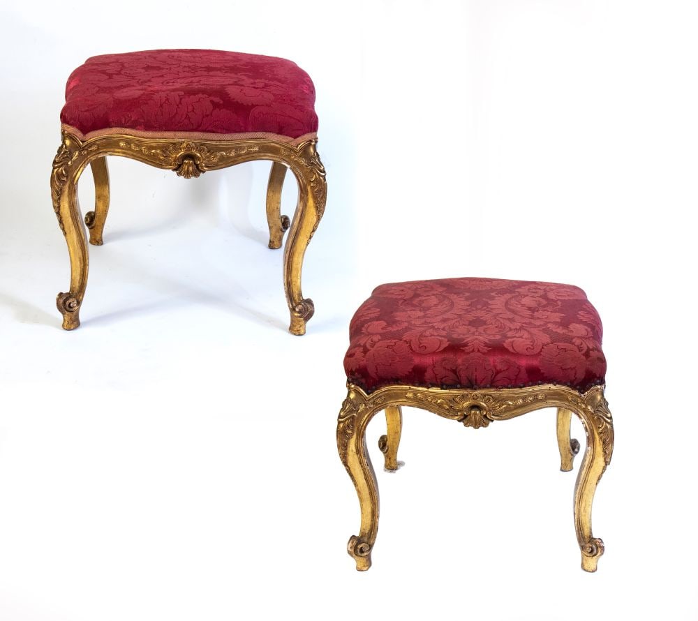 A pair of Louis XVI style gilded stools - Italy, 19th century: A pair of Louis XVI style gilded stools - Italy, 19th centuryHeight x width x depth: 45 x 48 x 48 cm.of carved and gilded wood, with scroll-shaped legs and crossbars carved with central rocaille motif