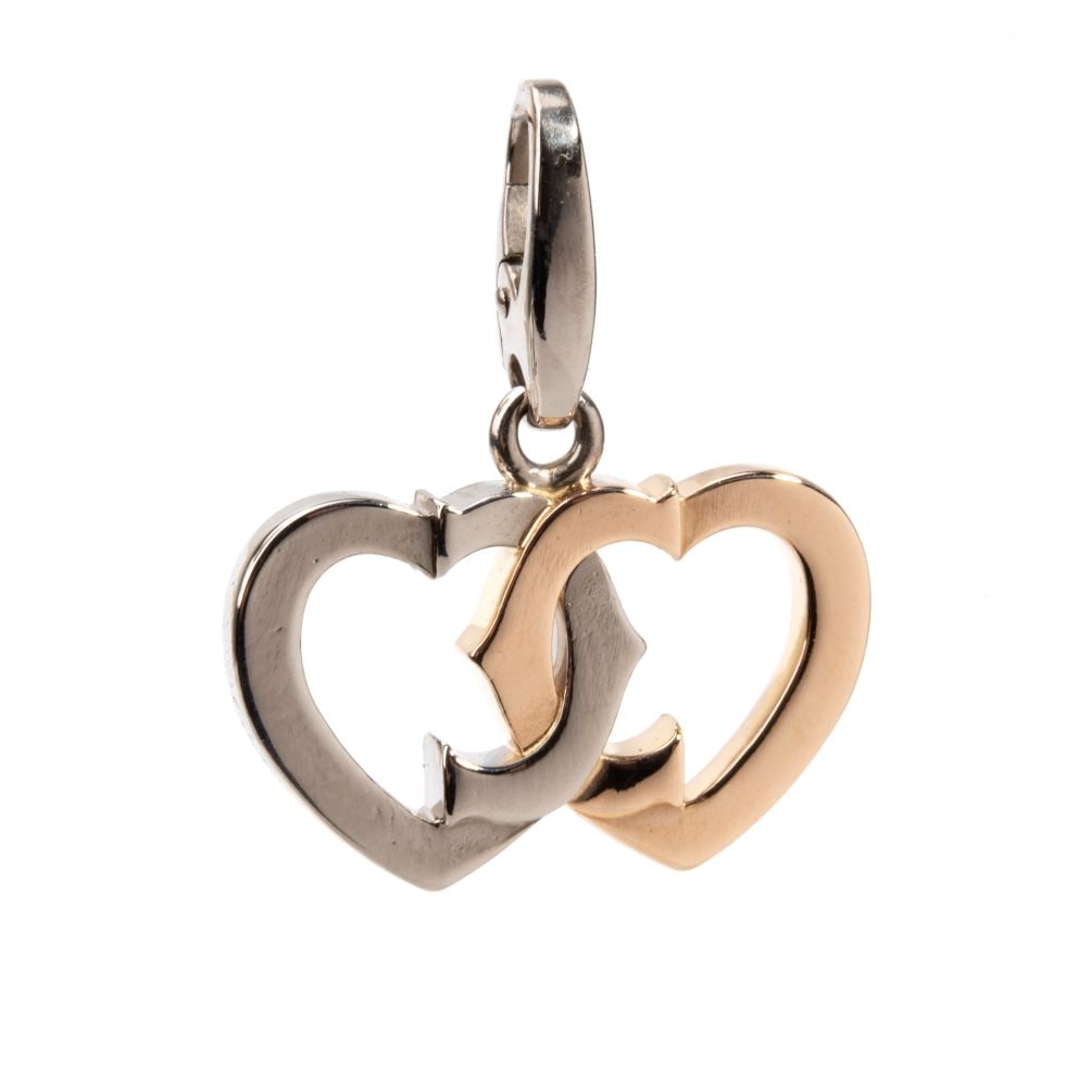 CARTIER Gold pendant: CARTIER Gold pendant 18k white and yellow gold, featuring a stylised design of a pair of intertwined hearts. Signed CARTIER.Hallmarked “750 - D044495”. Front dimensions: 2 x 1.5 cm. Weight: 5 