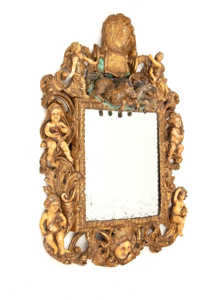 Carved and gilded mirror: Carved and gilded mirrorHeight x width x depth: 72 x 46 x 12 cmSicily, mid-18th centurygilded, with figurative wooden inlays. The cornice is dominated by a large radial shell valve beneath which