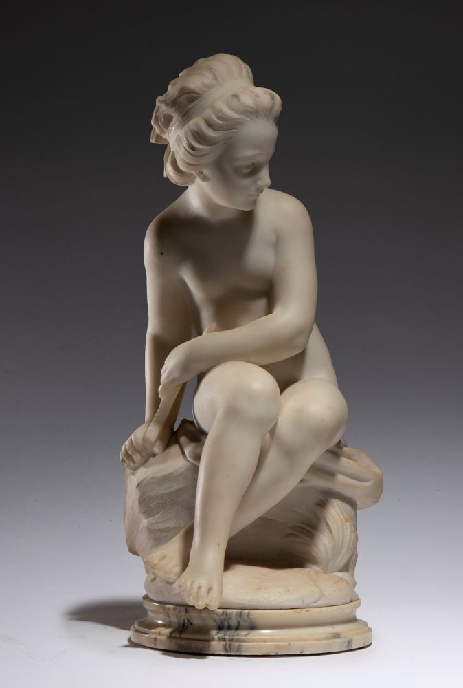 “The Bather,” a marble sculpture: “The Bather,” a marble sculptureHeight x width x depth: 59 x 29 x 33 cmFrance, 19th centurya statue in white statuary marble depicting a nude Venus about to take a bath, a copy of the
