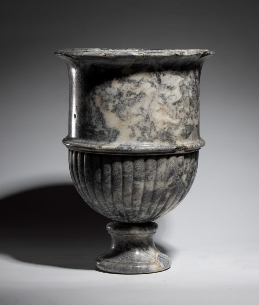 African Marble Crater Vase: African Marble Crater VaseHeight x diameter: 60 x 32 cmItaly, 19th centurythe lower part features vertical ribbing, while the upper part is smooth, as in classic models. Minor imperfections.This lot