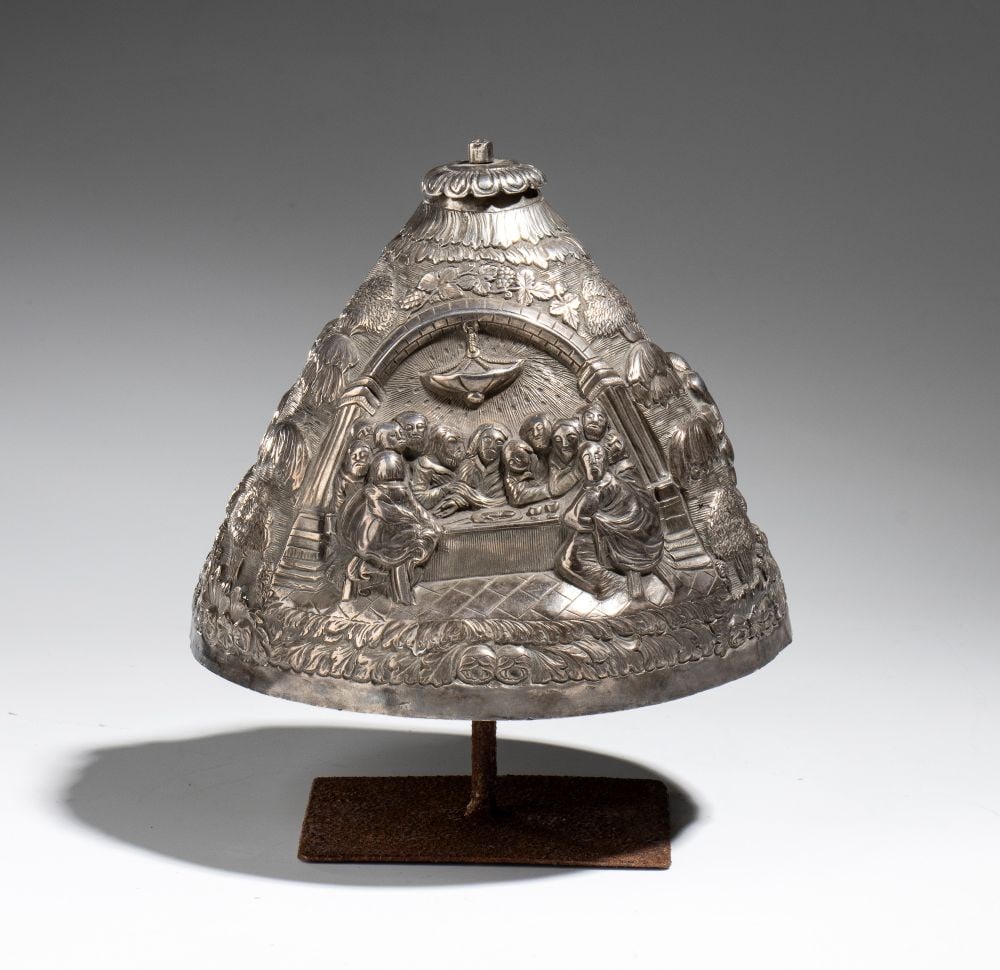 A ciborium lid made of embossed and engraved silver depicting scenes from the life of Christ: A ciborium lid made of embossed and engraved silver depicting scenes from the life of ChristHeight × diameter: 20 x 16 cmItaly, 18th centuryConical in shape, it is entirely decorated with scenes