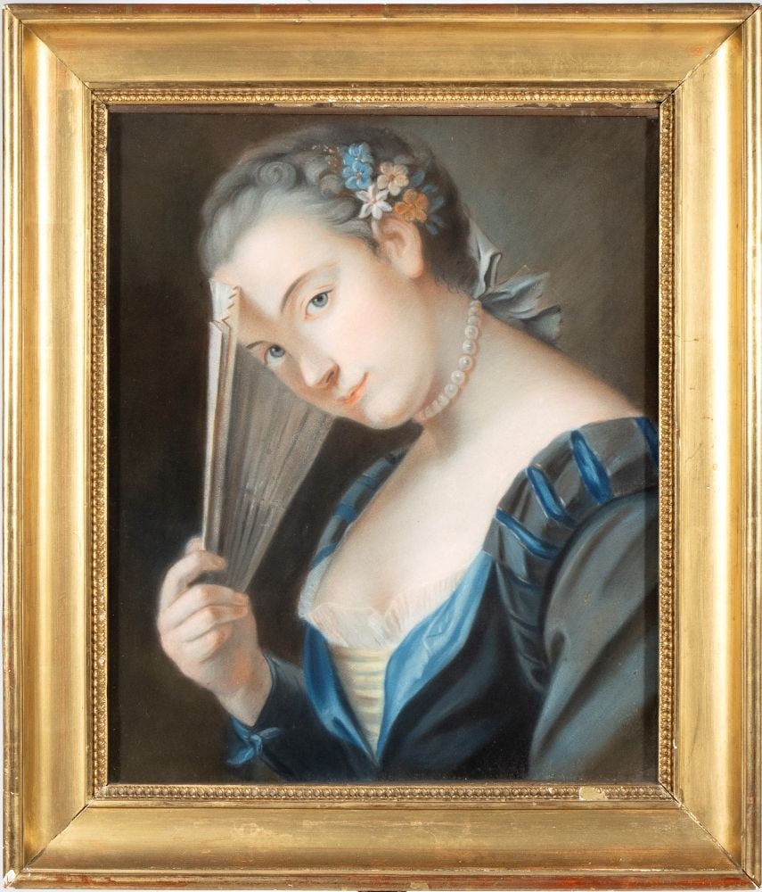 Portrait of a Lady with a fan: Portrait of a Lady with a fanHeight x width: 59 x 50 cm19th centuryThe figure is wearing a blue silk dress with ribbons and wide sleeves, a light-colored striped bodice, and a pearl necklace. Her