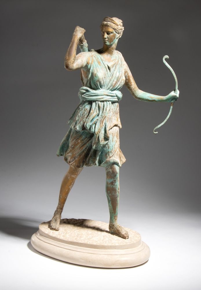 Sculpture of the goddess Diana: Sculpture of the goddess DianaHeight x width x depth: 61 x 30 x 38 cm19th century made of iron with an oval marble base; also known as Artemis in Greek mythology.This lot is currently in storage