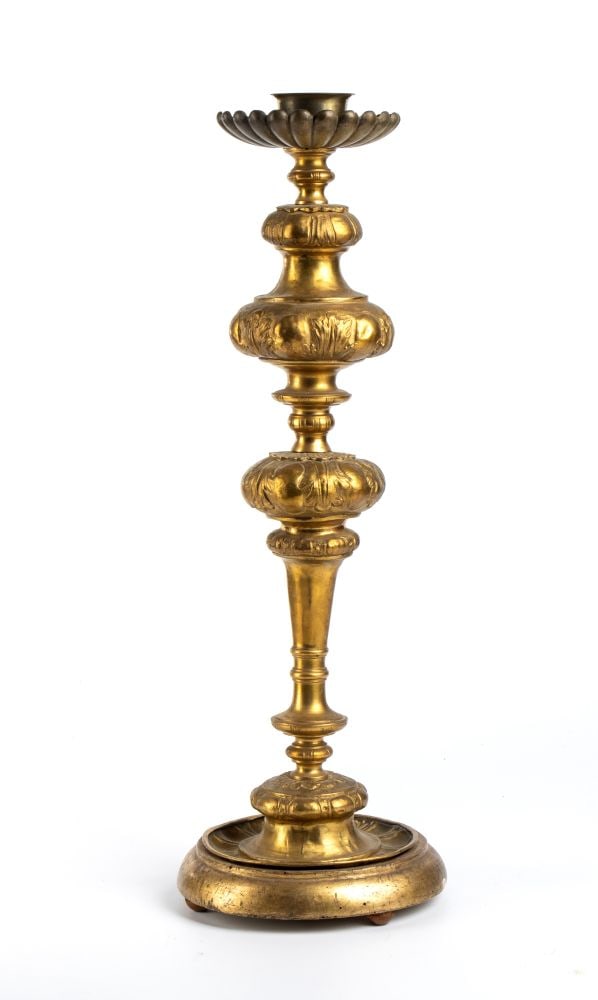 Brass candlestick with gilded wooden base: Brass candlestick with gilded wooden baseHeight x diameter: 52,5 x 17 cm.Italy, 19th centuryThis lot is currently in storage in Piobbico (PU) with the owner. To view it in person, please