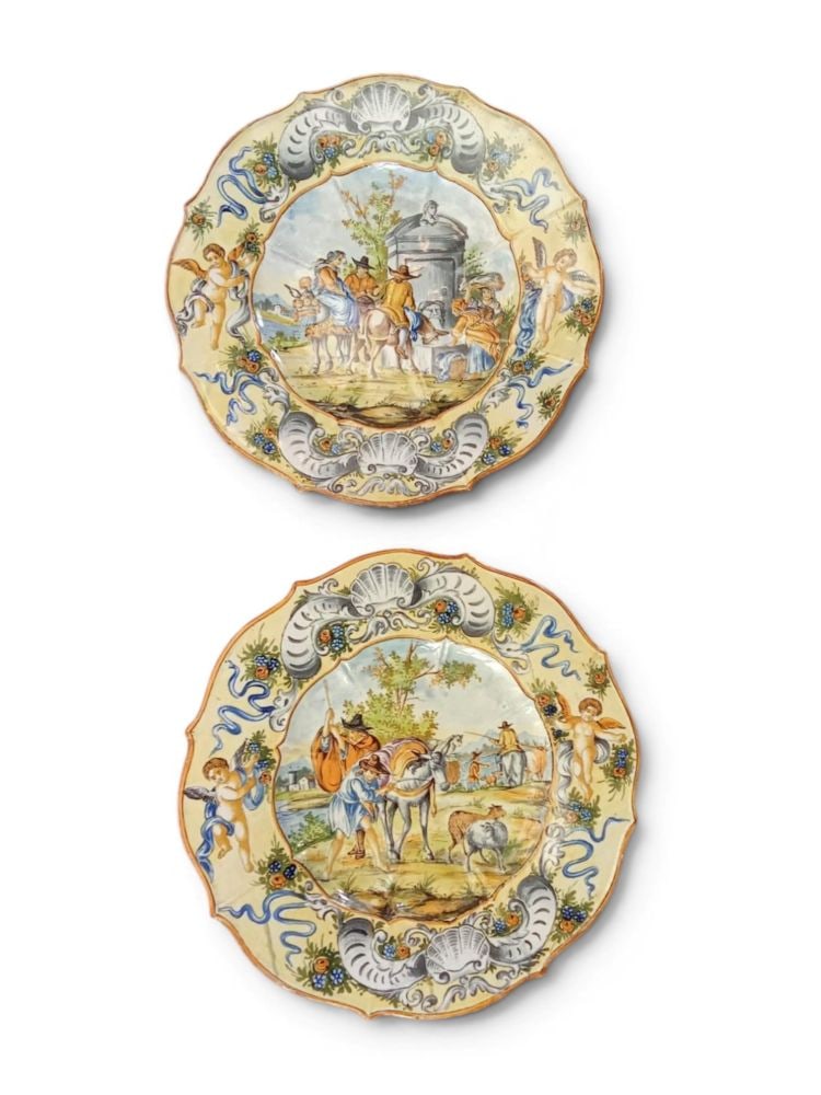 Set of two decorative majolica plates: Set of two decorative majolica platesDiameter: 38 cmItaly, 20th centurydecorated with scenes of an Arcadian and pastoral nature.This lot is currently in storage with the owner.To view it in person, pl