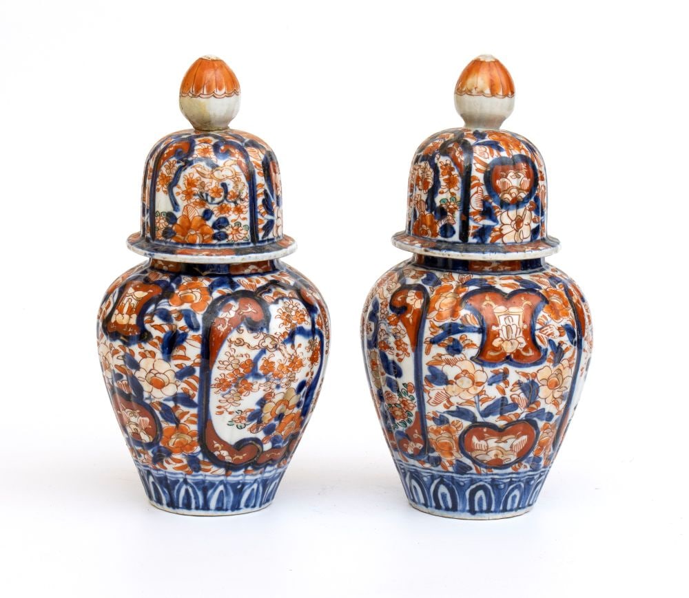 A pair of Imari vases: A pair of Imari vasesHeight x diameter: 24 x 11.5 cm.Japan, 19th centuryaintings with floral motifs in shades of blue and orange on a white background. Item condition grading: **** good.One of