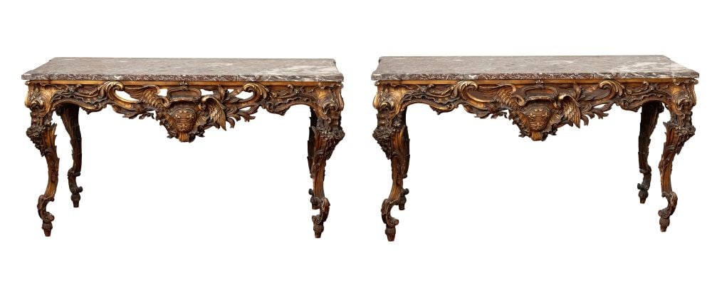 Pair of Louis XV-style side tables in carved and gilded wood - Central Italy, first half of 19th: Height x width x depth: 73 x 181 x 100 cmcharacterized by a dynamic structure with strongly sinuous legs and rich rocaille decoration. The front is centered by a prominent cartouche bearing a coat of 