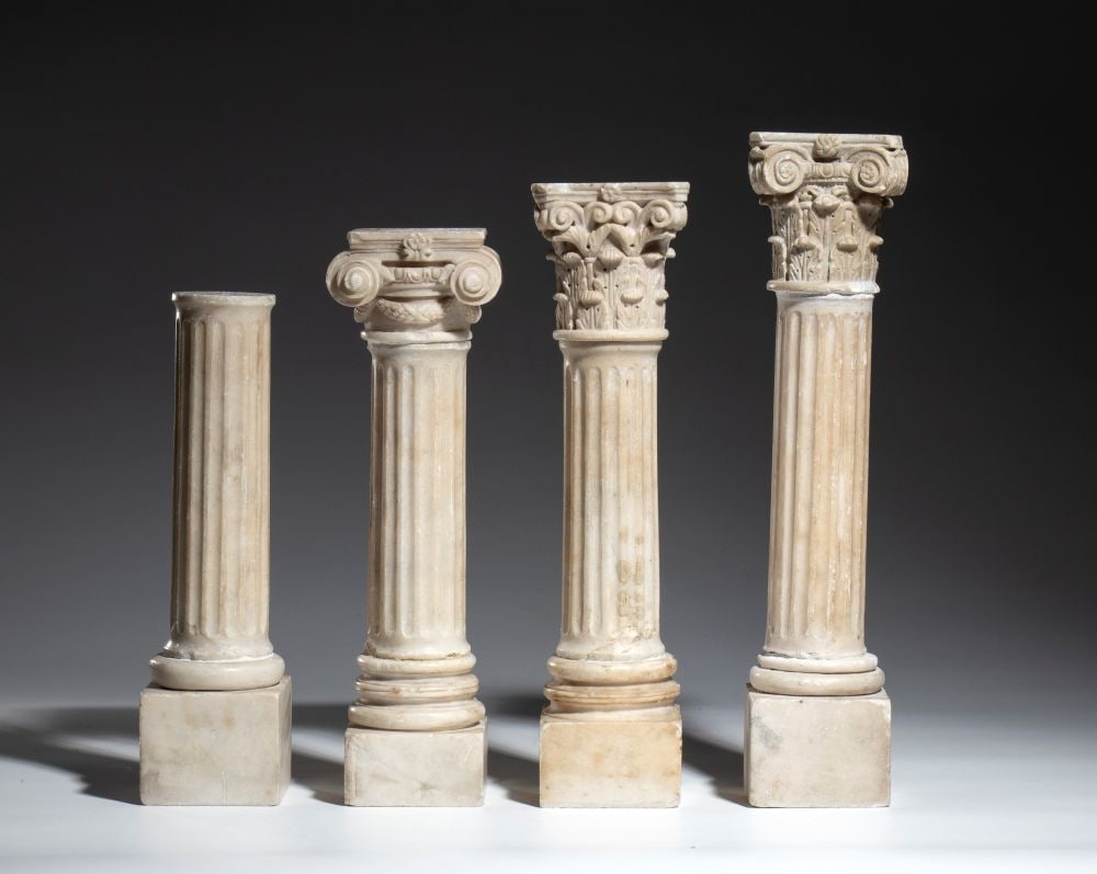 Four models of Louis XVI-style columns - Late 18th century: Height x diameter: 27-37 x 8 cmfinely carved from marble. The series illustrates the evolution of architectural orders and includes Doric, Ionic, Corinthian, and Composite columns, each resting on a s