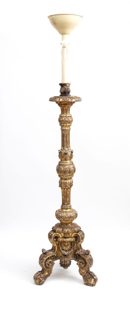 Carved and gilded wooden candlestick from Mecca - Italy, 18th century: Height x width x depth: 197 x 52 x 52 cm the shaft is richly carved with leaf motifs, pods, flower corollas, and vertical fluting. It rests on an imposing, ornate tripod base that ends in stylized cat