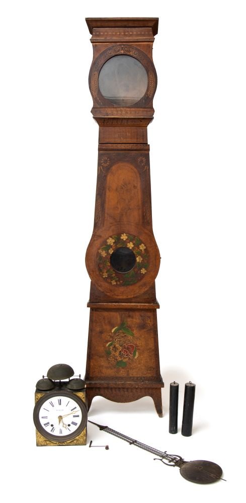 Column clock by Pietro Bini - Italy, 19th century: Height x width x depth: 234 x 45 x 21 cmInlaid wooden column-style clock case with a projecting cornice and an upper door featuring a circular window. The central body has a contoured door, adorned wi