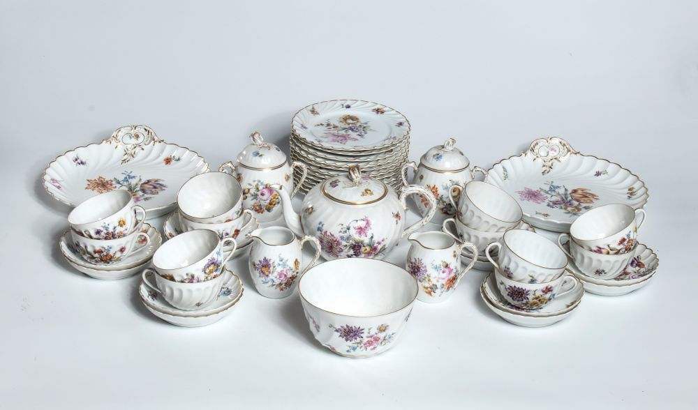 Porcelain tea set, Nymphenburg - Germany, 20th century: made of white porcelain, finely decorated with multicolored floral bouquets and gold-trimmed edges. The set consists of 44 pieces: 12 cups, 12 saucers, 12 plates, 2 cookie plates, 1 teapot, 2 sugar bo