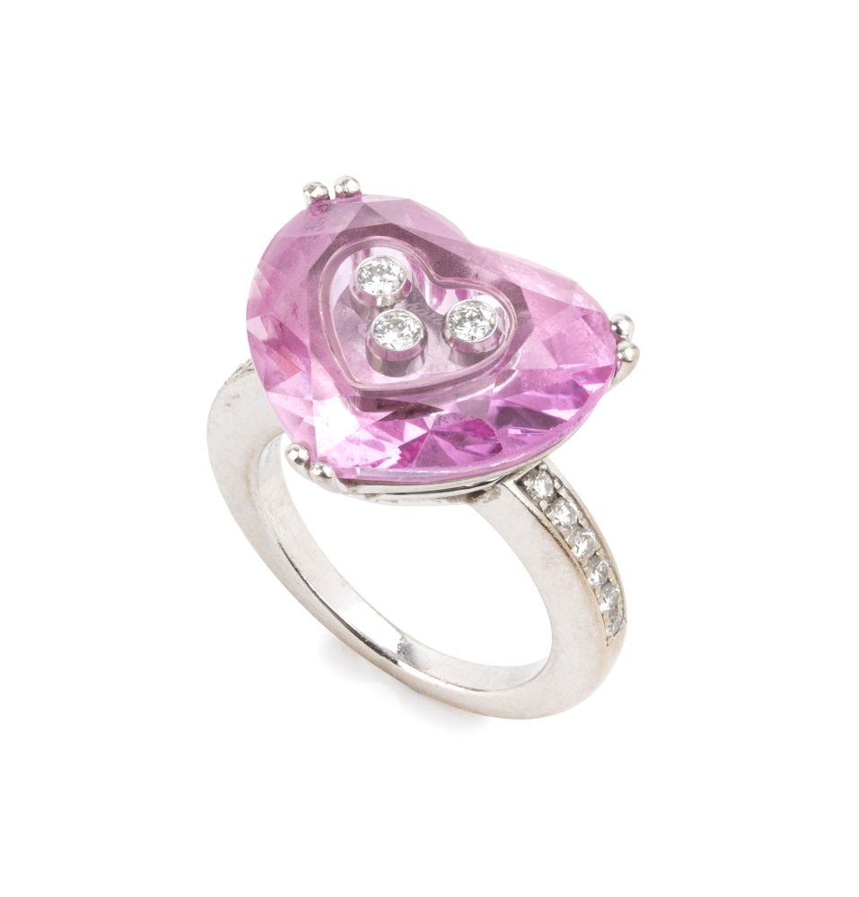CHOPARD Happy Diamonds Collection, heart-shaped ring in gold, diamonds and glass: 18k white gold, with three movable diamonds set between two sapphire crystals; the shank accented by rows of brilliant-cut diamonds, totalling approximately 0.12 ct.Hallmarked “750 – 61682