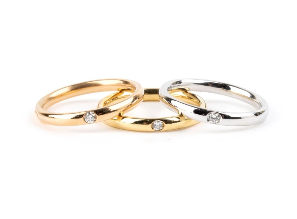POMELLATO Fireflies Collection: three gold rings set with diamonds: 18k white, rose and yellow gold, each set with a small brilliant-cut diamond.Hallmarked “750 – 419 AL - 1695 MI”. Signed "POMELLATO". IT size 10 ½ – US size 5 ½. Weig