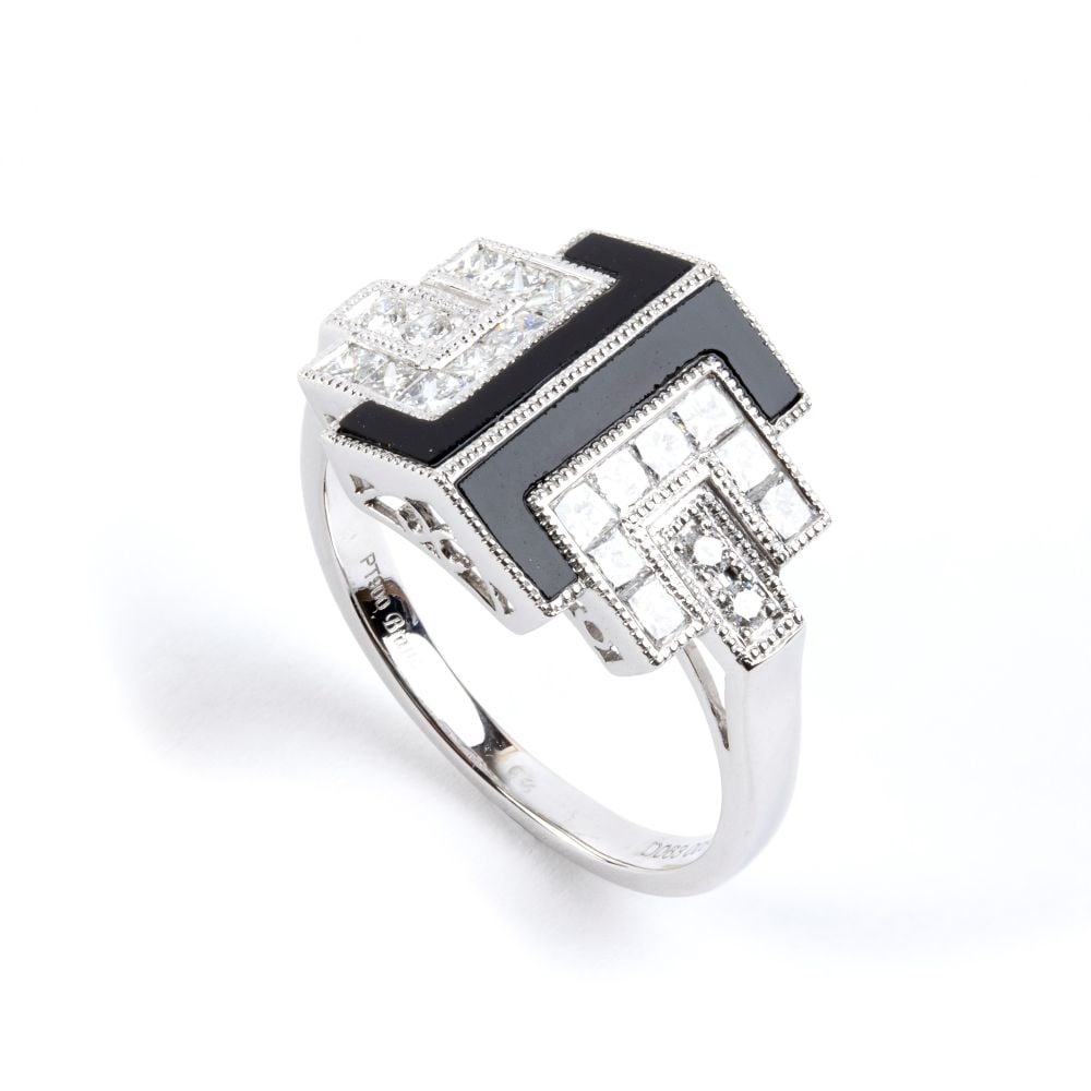 BRANAR PARIS Diamond onyx Déco style platinum ring: Featuring a platinum buckle motif set with onyx, brilliant-cut and princess-cut diamonds, estimated to weight a total of approx. 0.71 ct, colour F-G, clarity VVS-VS, as gauged and graded in the