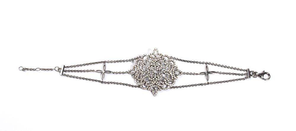 Diamond gold bracelet: 18k white gold, with a central floral design featuring interwoven ribbons set with round brilliant-cut diamonds, estimated to weigh a total of approx. 4.20 ct, H-I colour, VS-SI clarity, as gauged and