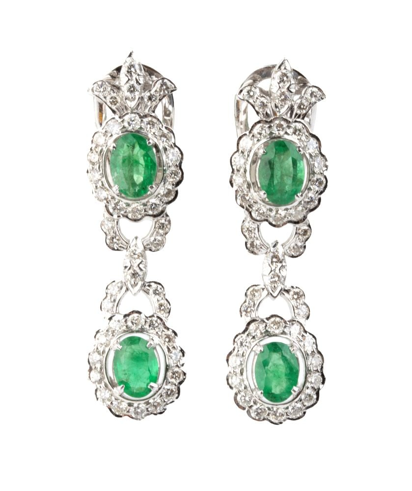 Emerald diamond gold drop pair of earrings: 18k white gold, each featuring a pair of emerald and diamonds floral motifs, linked by diamond ribbons.N. 04 oval-shaped emeralds, composite cut, estimated to weigh approximately 2.20 ct, and 88 round