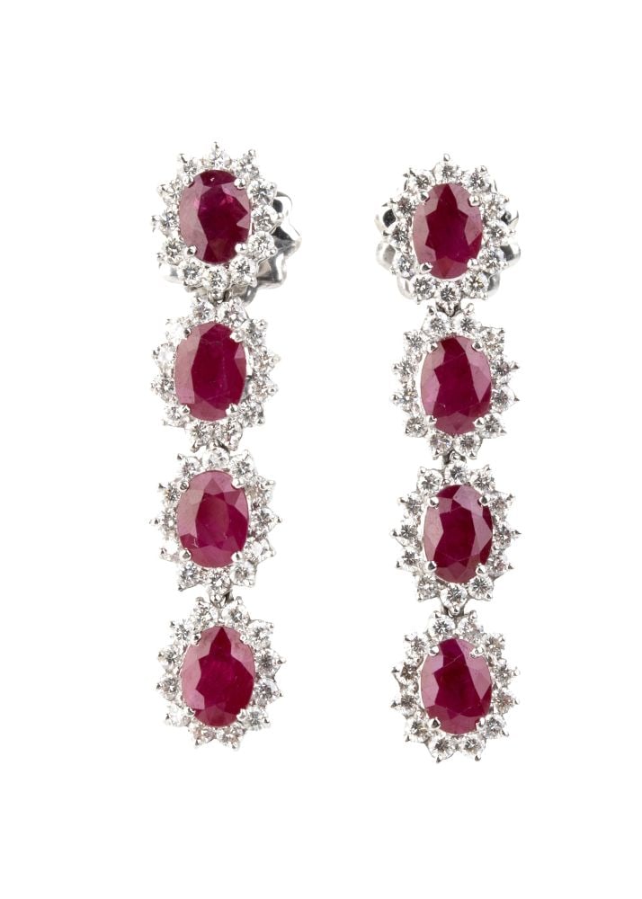 Ruby diamond gold drop pair of earrings: 18k white gold, set with a line of oval shaped rubies estimated to weigh approx. 9.50 ct, framed by brilliant-cut diamonds estimated total weight of approx. 2.40 ct, colour G-H, clarity IF-VVS.Hallmar