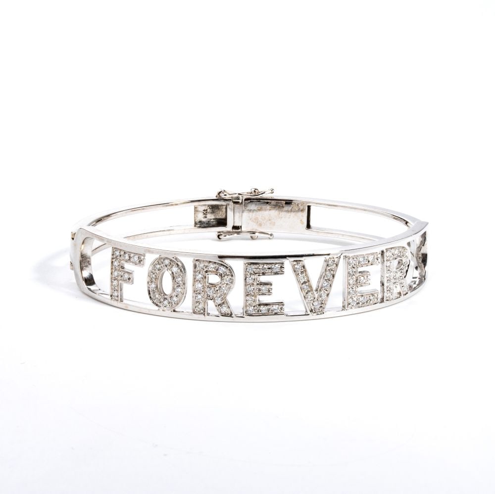 Diamond gold bracelet: a rigid openwork 9k white gold hoop bracelet, with letters that make up the word "FOREVER" in round brilliant-cut diamonds, estimated total weight approx. 1.70 ct, colour F-G, clarity VVS-VS, as