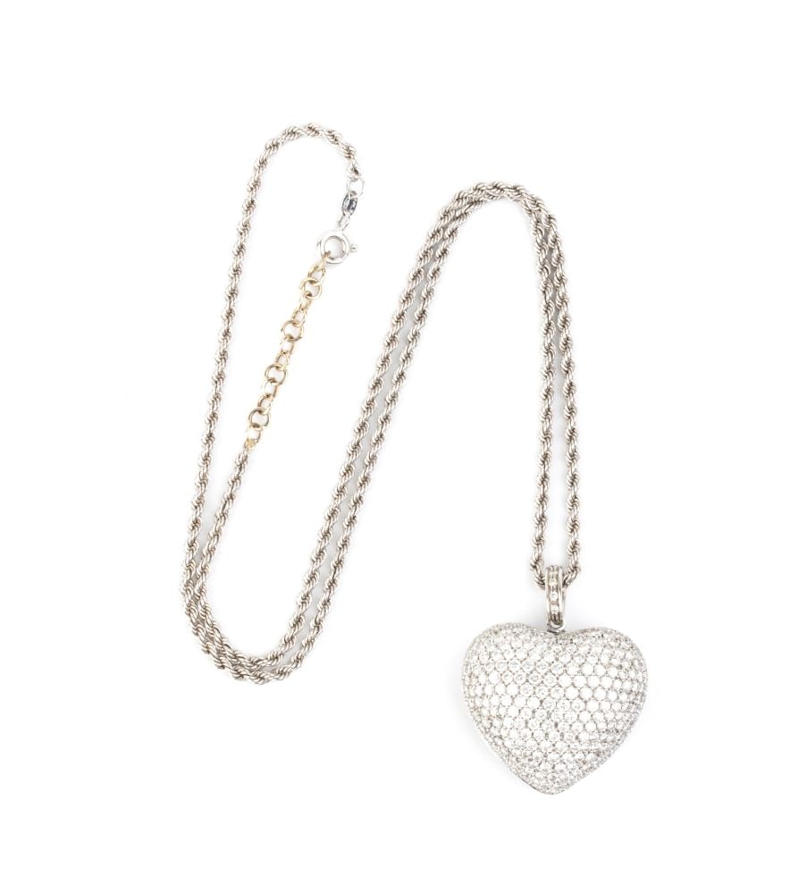 Diamond gold necklace-pendant: A sparkling array of tiny bright-white small round brilliant-cut diamonds pave set over a gently domed 18k white gold heart, suspended from a twisted link chain. The reverse is adorned with an
