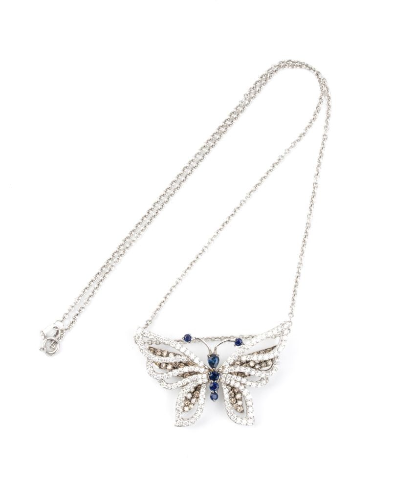 Diamond sapphire gold necklace pendant-brooch: 18k white gold, with a forzatina-link chain from which hangs a pendant that can also be worn as a brooch, depicting a butterfly with a sapphires body and diamonds wings.Colourless round brilliant-cut