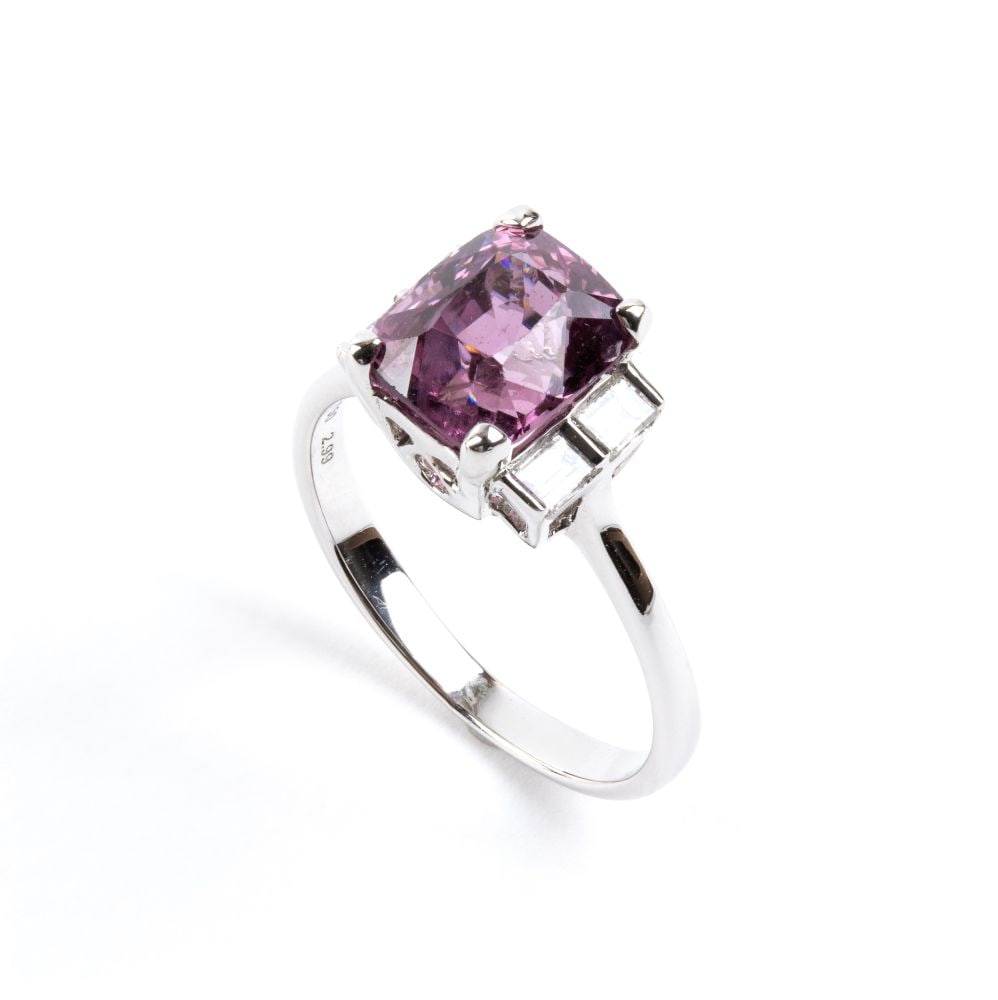 Spinel diamond gold ring: 18k white gold, set with a spinel estimated to weigh approx. 2.99 ct, flanked by two pairs of baguette-cut diamonds estimated to have a total weight of approx. 0.25 ct, colour F-G, clarity VVS-VS, as