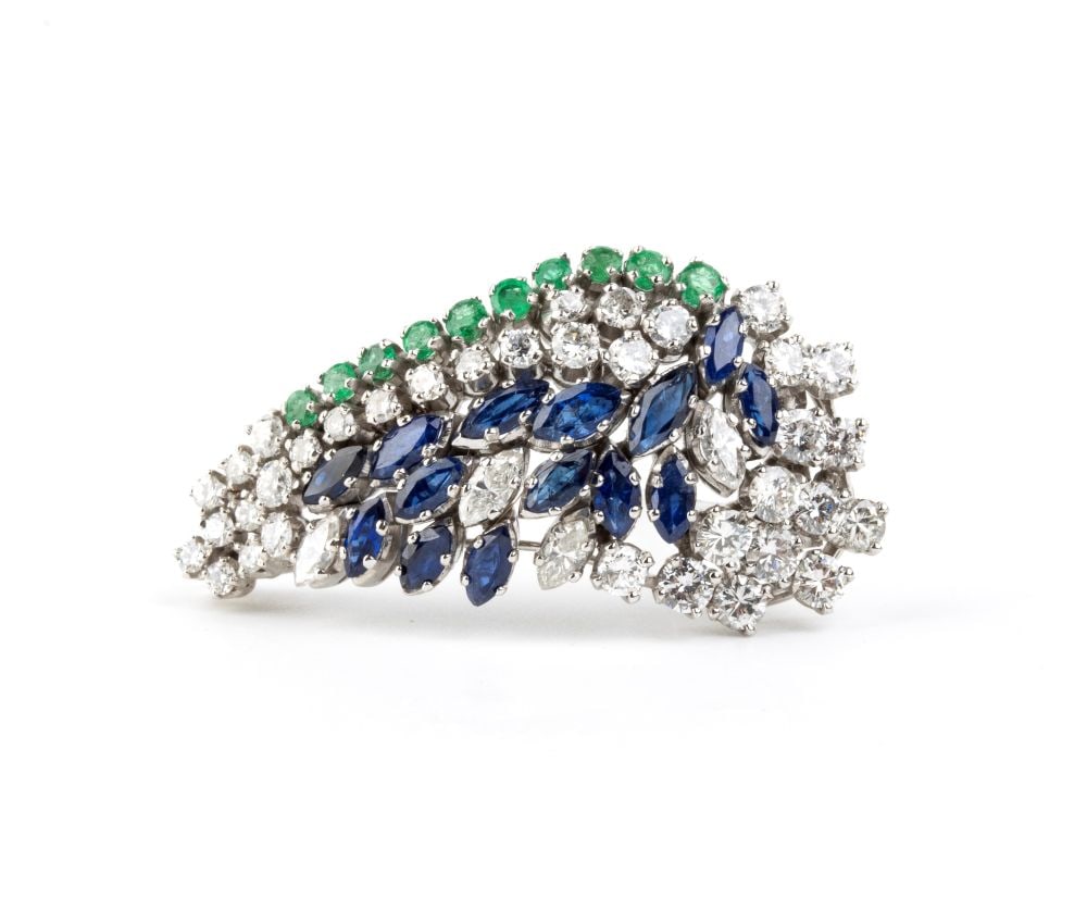 Diamond sapphire emerald gold brooch: 18k white gold, set with navette-cut sapphires with an estimated weight of approximately 2.10 ct, round emeralds with an estimated weight of approximately 0.50 ct, and brilliant-cut diamonds with an