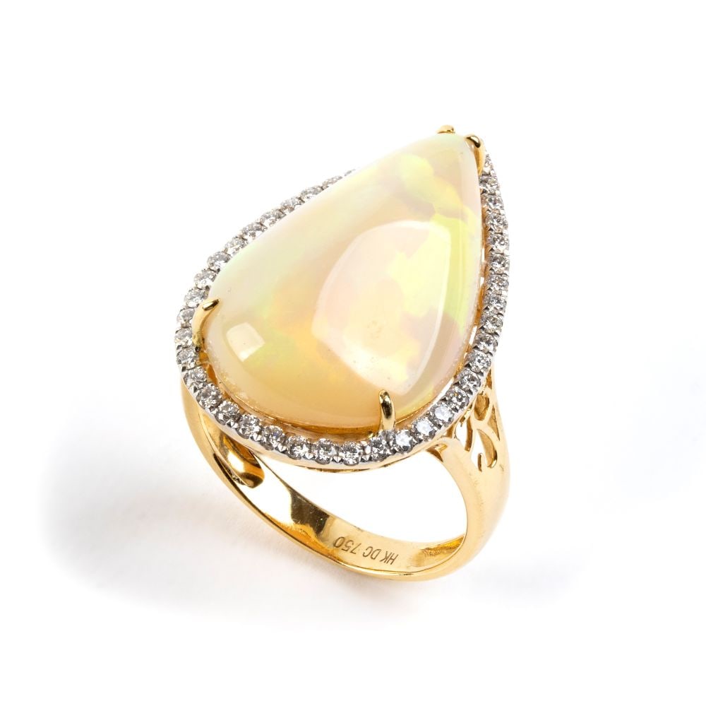 Opal diamond gold ring: 18k yellow gold, set with a teardrop-shaped opal framed by round brilliant-cut diamonds, estimated to have a total weight of approx. 0.45 ct, colour G-H, clarity VVS-VS, as gauged and graded in the