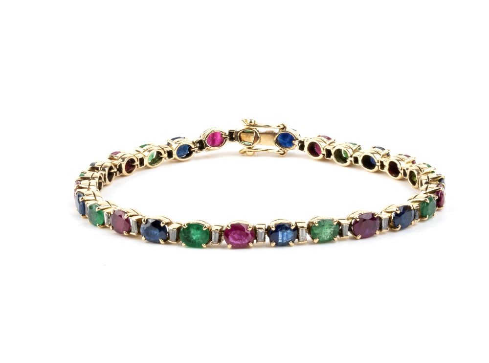 Emerald ruby sapphire diamond gold tennis bracelet: 18k yellow gold, set with a row of sapphires, emeralds separated by baguette-cut diamonds with an estimated total weight of approx. 0.80 ct, colour H-I, clarity VS-SI, as gauged and graded in the moun