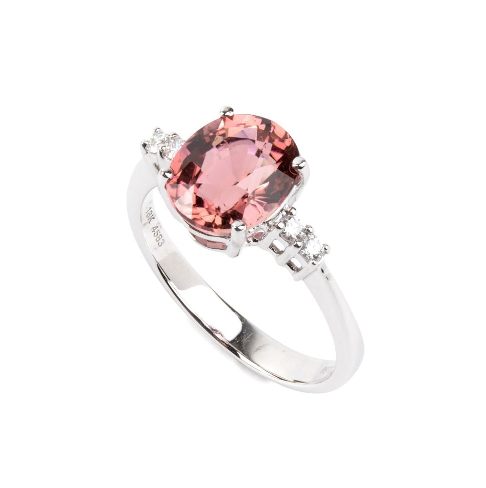 Tourmaline diamond gold ring: 18k white gold, set with an oval tourmaline estimated to weigh approx. 2.56 ct, flanked by two pairs of round brilliant-cut diamonds, estimated to have a total weight of approx. 0.08 ct, as gauged