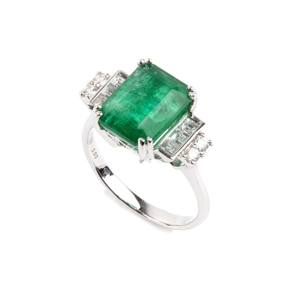 Emerald diamond gold ring: 18k white gold, set with an emerald-cut emerald, estimated to weigh approx. 3.93 ct, flanked by brilliant-cut and baguette-cut diamonds estimated to weigh a total of approx. 0.30 ct, colour G-H,