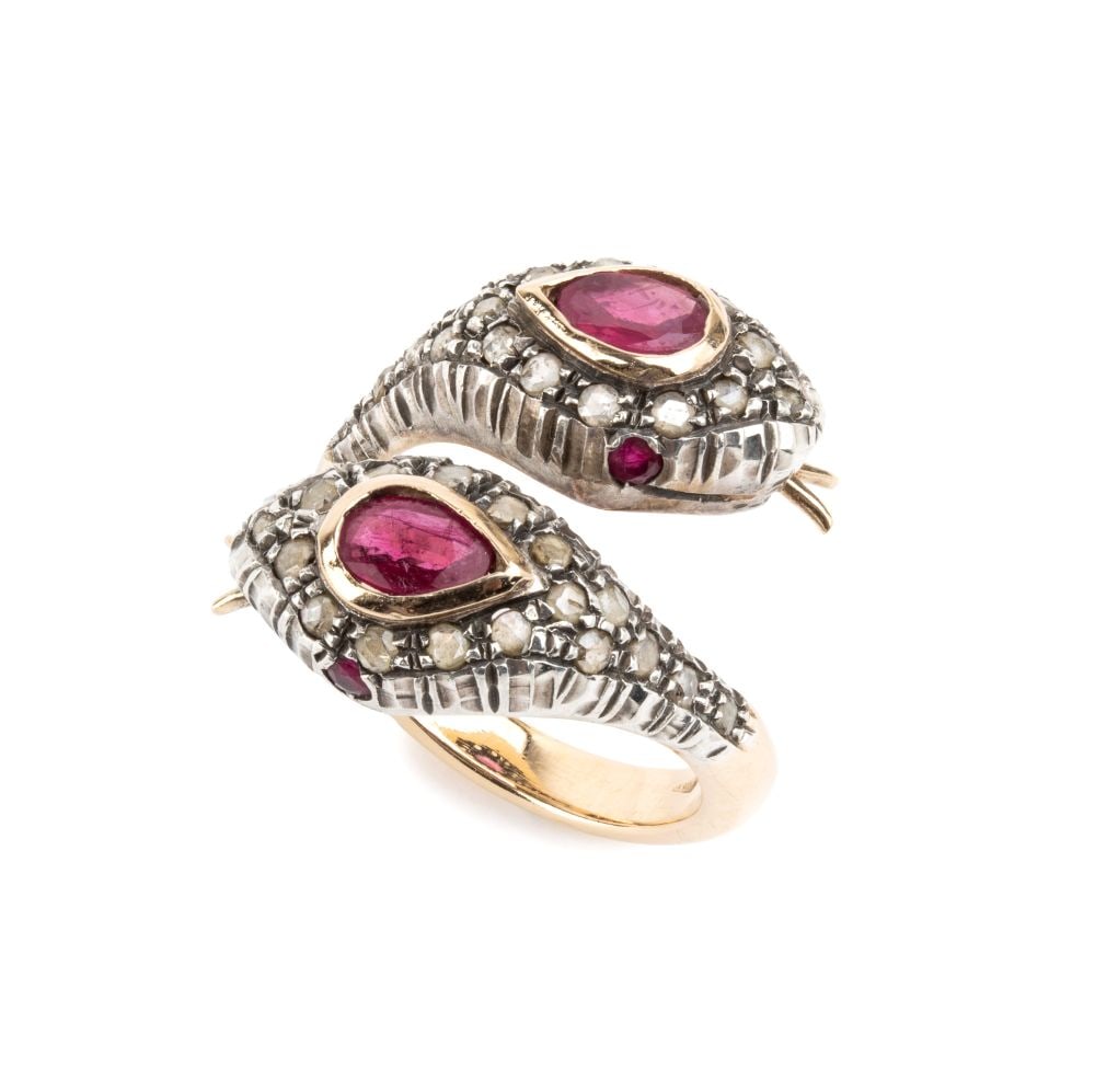 Gold and silver "snake" ring set with Burmese rubies and diamonds.: Silver and 14k yellow gold "contrarié’ ring featuring a pair of snakes heads each set with a Burmese ruby and a pavé setting of rose-cut diamonds; small rubies eyes. N. 02 rubies,
