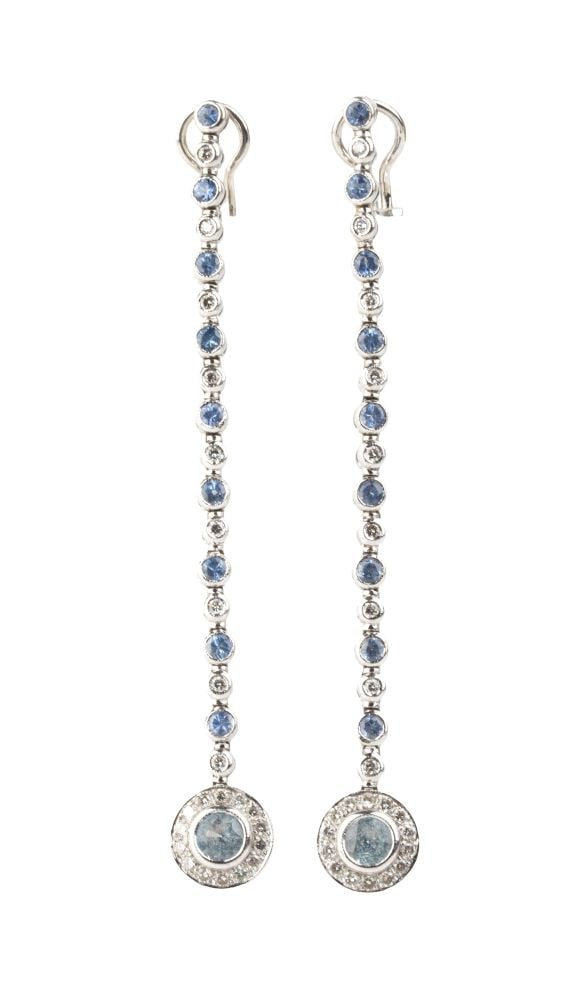 Blue topaz diamond gold drop pair of earrings: 18k white gold, set with a line of light blue topazes alternating with brilliant-cut diamonds, estimated total weight of approx. 0.80 ct, colour G-H, clarity VS-VS.Hallmarked "750".Length: 8 cm.