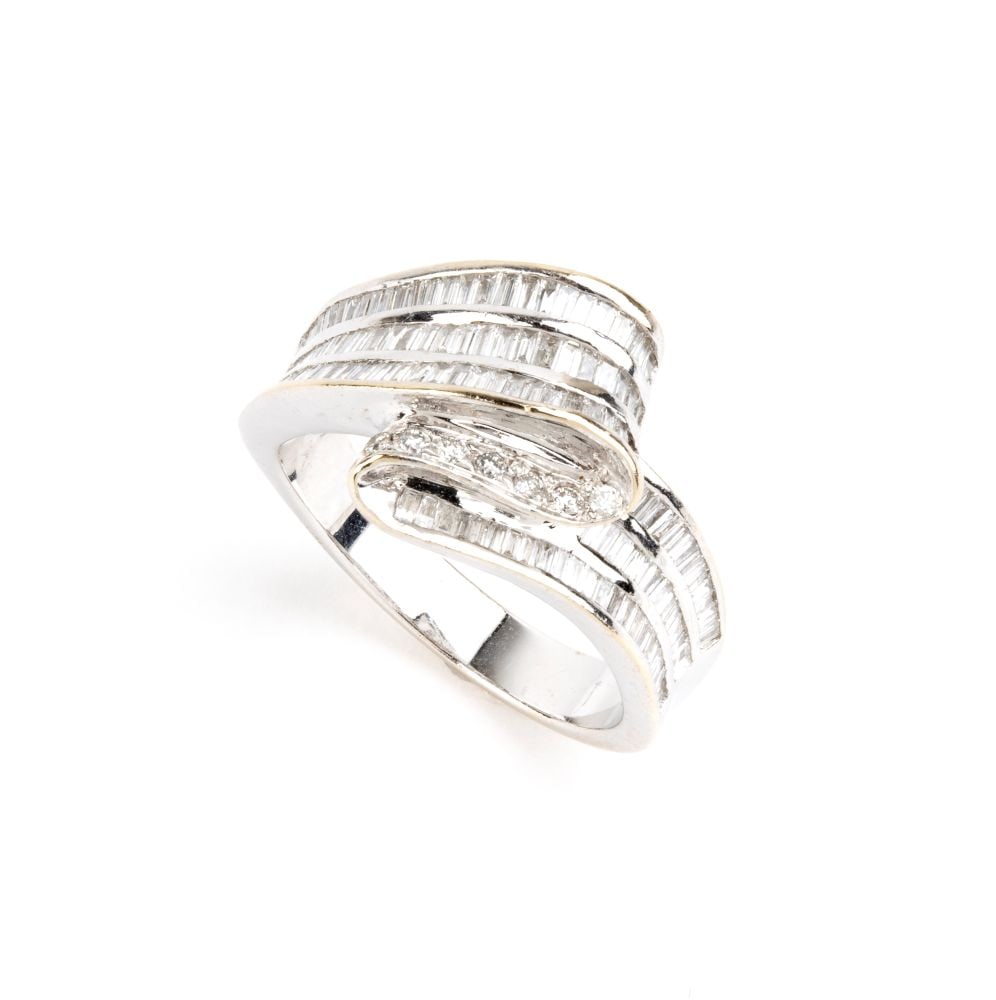 Diamond gold ring: Featuring an 18k white gold wavy ribbon, set with baguette-cut and tapered-cut diamonds, estimated a total weight of approx. 3.40 ct.Hallmarked "750".IT size 15 – US size 7 ½. Weight: 7 g.