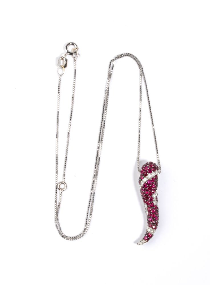 Diamond rubies gold necklace and pendant: 18k white gold, featuring a pendant in the shape of a scaramantic horn, with pavé set diamonds and rubies. Round brilliant-cut diamonds, estimated total weight approx. 0.70 ct, colour F-G,
