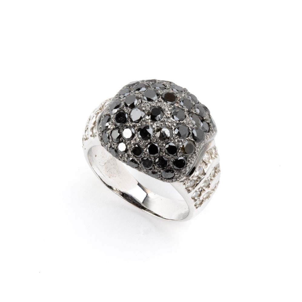 Black and colourless diamond gold band ring: 18k white gold, with a pavé set of colourless brilliant-cut diamonds shank, estimated to weigh a total of approx. 0.38 ct, and a dome-shaped centre with black diamonds pave set. Size IT 11
