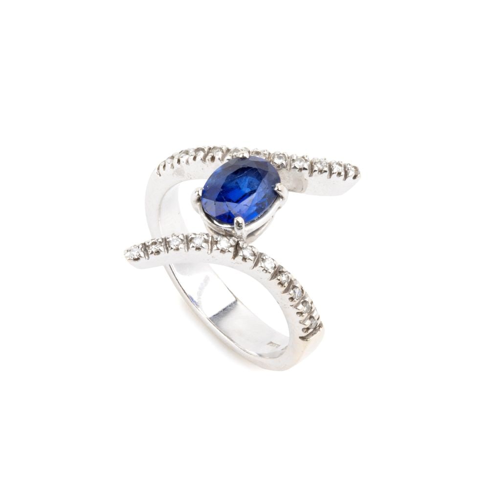 Blue sapphire diamond gold ring: 18k white gold, set with an oval sapphire estimated to weigh approx. 1.50 ct, held in place by brilliant-cut diamonds thin ribbons, estimated to weigh a total of approx. 0.30 ct, colour H, clarity