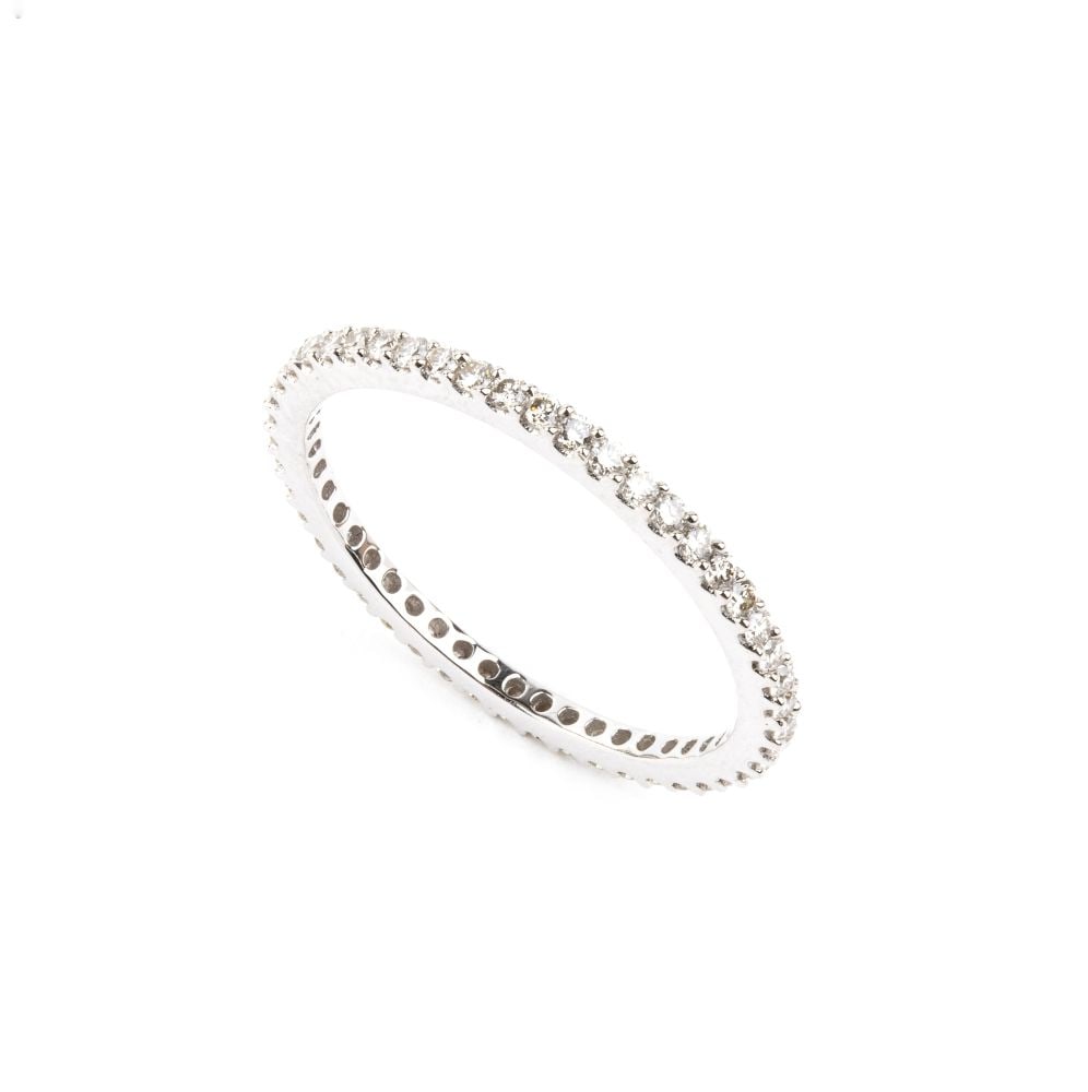 Eternity diamond gold ring: 18k white gold, set with line of round brilliant cut diamonds, estimated to weigh a total of approx. 0.70 ct, G-H colour, VS-SI clarity, as gauged and graded in the mount.Hallmarked “french