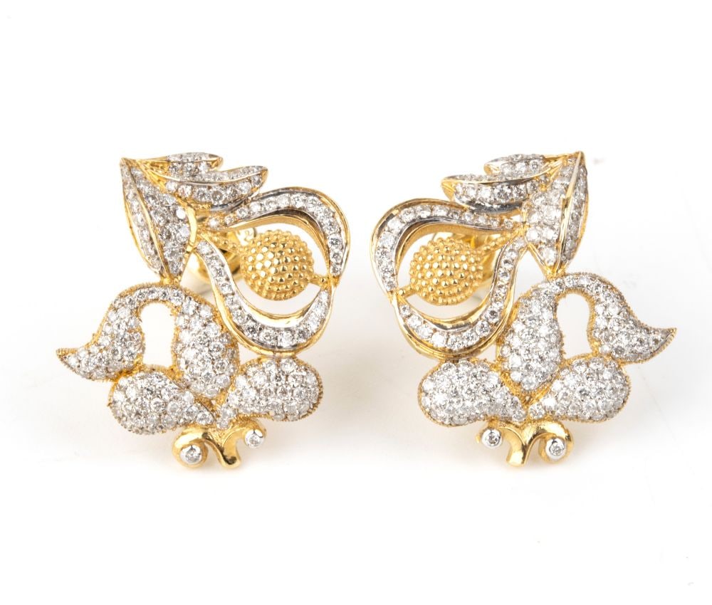 Diamond pair of earrings: 18k yellow and white gold, featuring an asymmetrical and mirror-image design inspired by nature, with scrolls and floral forms, set with brilliant-cut diamond,s estimated total weight of