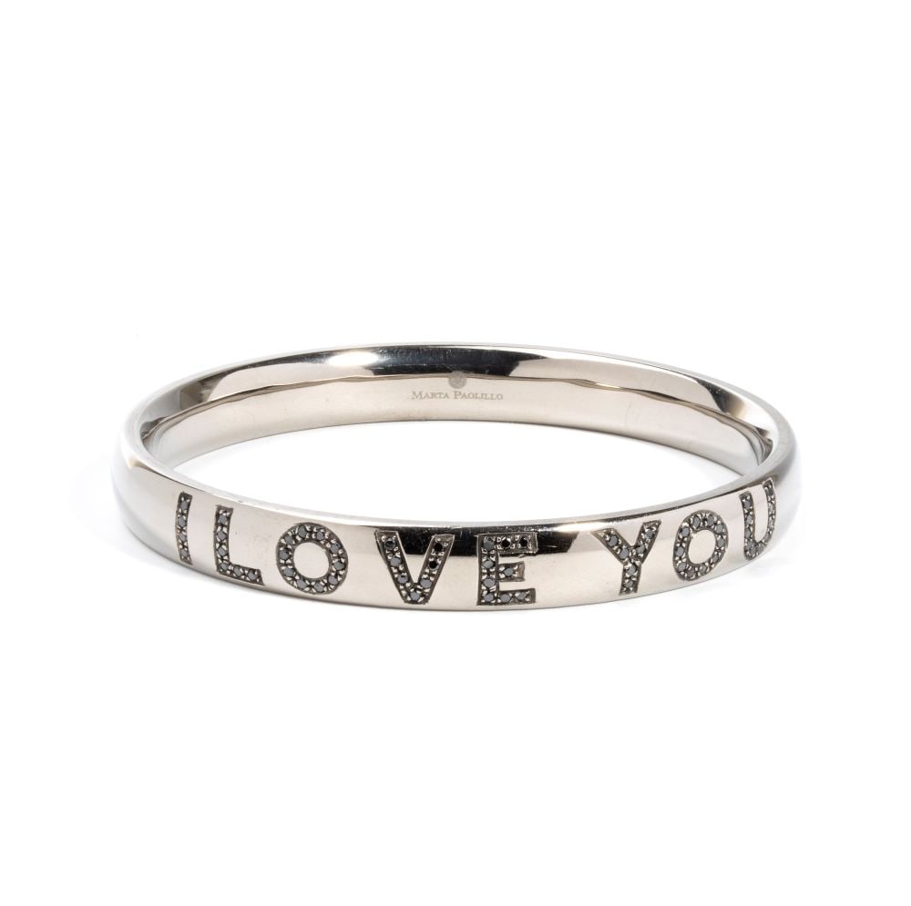 Diamond rigid bracelet: with the inscription "I LOVE YOU" in round brilliant-cut black diamonds. Signed MARTA PAOLILLO.Inner diameter: 6.5 cm. Weight: 29.8 g.