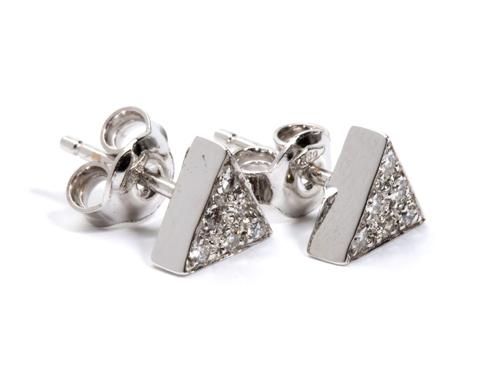 A pair of geometric gold and diamond earrings: triangular shaped, 18k white gold, with pave set round brilliant-cut diamonds, estimated to weigh a total of approx. 0.12 ct, G-H colour, VVS-VS clarity, as gauged and graded in the mount.Hallmarked